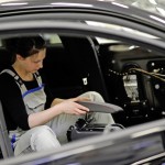 Volkswagen Golf GTI Black Dynamic Apprentice automotive mechatronics technician Lisa Batke working on the Golf GTI interior.
